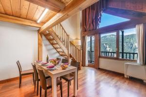 a dining room with a table and a large window at Residence Cianfuran in Bardonecchia