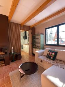 a living room with a couch and a table at Apartment on the ski slope Pohorje 11 in Hočko Pohorje