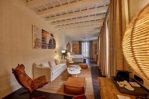 a living room with a white couch and a table at Puro Grand Hotel in Palma de Mallorca