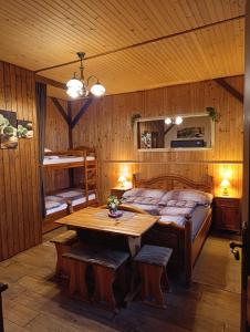 a bedroom with a bed and a table in it at Rustic Eden in Liptovský Mikuláš