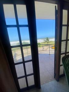 a view of the beach through a glass door at Mayura Beach Resort Matara in Matara