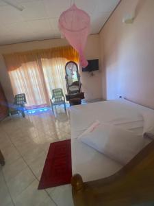 a bedroom with a large bed and a room with chairs at Mayura Beach Resort Matara in Matara