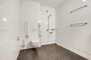 a white bathroom with a toilet and a shower at Summio Havenresort Terherne in Terherne +17 photos