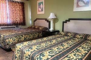 a hotel room with two beds in a room at Sun Star Inn Los Banos in Los Banos