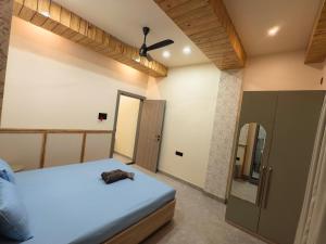 a bedroom with a bed and a mirror at Cordial Host in Guwahati
