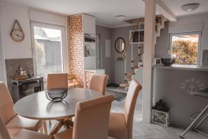 a kitchen and dining room with a table and chairs at Mö 71-Inselblick in Mönkebude +14 photos
