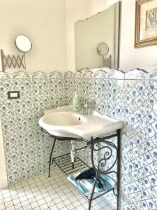 a bathroom with a sink and a mirror at Villa Rosa in Torre del Greco +30 photos
