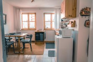 a small kitchen with a table and a refrigerator at Haffliebe in Ueckermünde +19 photos