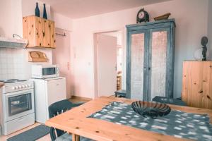 a kitchen with a wooden table and a kitchen with a microwave at Haffliebe in Ueckermünde