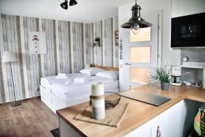 a small bedroom with a bed and a desk with a desk at Lagunenstadt am Haff - Fewo 166 Nautilus in Ueckermünde