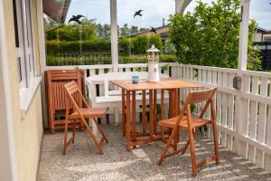 a porch with a table and chairs and a light on it at Turmhaus Mönkebude in Mönkebude