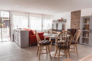 a kitchen and living room with a table and chairs at Turmhaus Mönkebude in Mönkebude