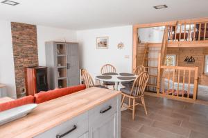 a kitchen and living room with a table and chairs at Turmhaus Mönkebude in Mönkebude