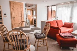 a living room with a table and a couch at Turmhaus Mönkebude in Mönkebude +21 photos