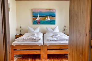 a bedroom with two beds with sails on the wall at Strandhaus 38 in Mönkebude +12 photos