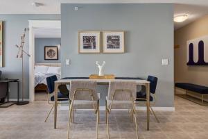 a dining room with a table and four chairs at Stylish Mountain View Condo with Gym in Canmore