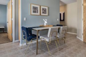 a dining room with a table and blue chairs at Stylish Mountain View Condo with Gym in Canmore