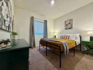 a bedroom with a bed with a desk and a window at Attached Guest House in Woodland