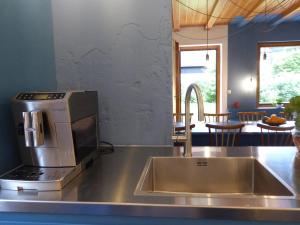 a kitchen with a sink and a microwave at King Ludwig's Old Neighbour in Schwangau +73 photos