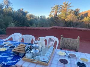 a table with a blue table cloth with food on it at Auberge sahnoun in Tafraout