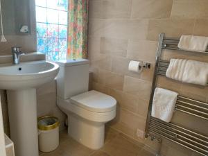 a bathroom with a white toilet and a sink at Walcot House in Fawley +20 photos