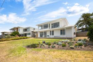 a house with a garden in front of it at Nest at Bashams - A Panoramic Oceanfront Sanctuary in Middleton