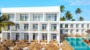 an exterior view of a resort with a swimming pool at AHG Sun Bay Mlilile Beach Hotel in Matemwe