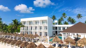 a resort with a pool and chairs and palm trees at AHG Sun Bay Mlilile Beach Hotel in Matemwe