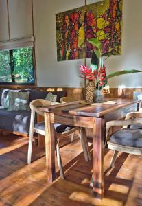 a wooden table and chairs in a living room at ANAVÁ Lodge de Selva y Piscina privada in El Soberbio