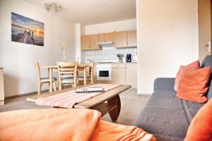 a living room with a couch and a table at Lagunenstadt am Haff - Fewo 4 Muschel in Ueckermünde