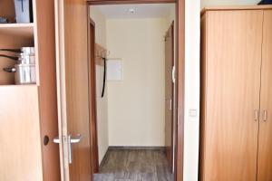 a room with a hallway with a door and a room with a hallway at Lagunenstadt am Haff - Fewo 196 Gaffel in Ueckermünde