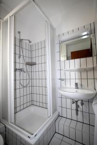 a bathroom with a shower and a sink at Lagunenstadt am Haff - Fewo 196 Gaffel in Ueckermünde +12 photos