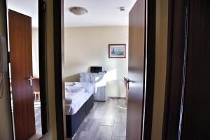 a small room with a bed and a bathroom at Lagunenstadt am Haff - Fewo 196 Gaffel in Ueckermünde