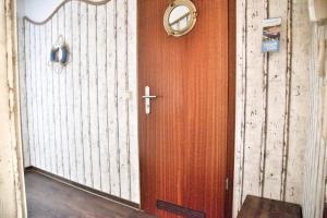 a wooden door with a cross and a mirror at Lagunenstadt am Haff - Fewo 72 Flip in Ueckermünde