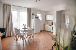 a kitchen and dining room with a table and chairs at Lagunenstadt am Haff - 80 Kai in Ueckermünde