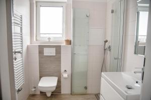 a small bathroom with a toilet and a sink at Lagunenstadt am Haff - 80 Kai in Ueckermünde +14 photos