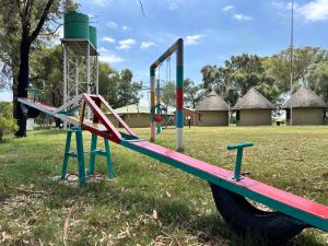 a playground with a slide in a park at De Rust Private Nature Reserve in Odendaalsrus