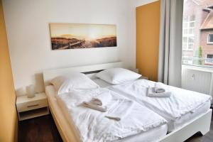 a white bed in a room with a window at Lagunenstadt am Haff - 133 Hol über! in Ueckermünde