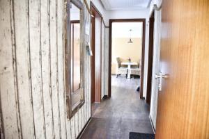 a hallway with wooden walls and a mirror at Lagunenstadt am Haff - 133 Hol über! in Ueckermünde +13 photos