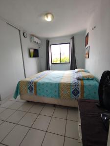 a bedroom with a bed and a window at Cumbuco Geek House in Cumbuco +10 photos