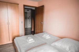 a bedroom with a bed with two towels on it at Lagunenstadt am Haff - 146 Oberlicht in Ueckermünde +18 photos