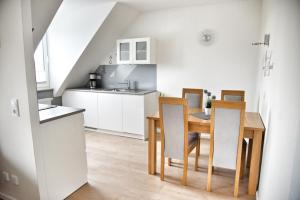 a kitchen and dining room with a table and chairs at Lagunenstadt am Haff - Fewo 161 Arielle in Ueckermünde