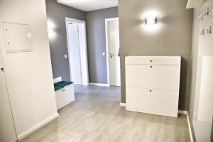 a room with a white dresser and two doors at Lagunenstadt am Haff - Fewo 161 Arielle in Ueckermünde +11 photos