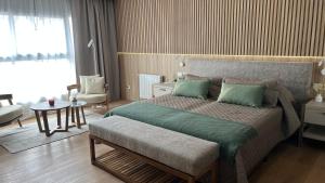 a bedroom with a large bed with green pillows at Empire Hotel Buenos Aires in Buenos Aires