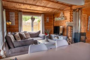 a living room with a couch and a table at Ferienhaus Ankerplatz Bellin in Ueckermünde