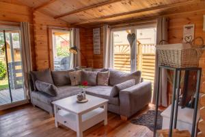 a living room with a couch and a table at Ferienhaus Ankerplatz Bellin in Ueckermünde
