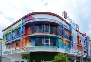 a multicolored building with a rainbow at Hotel de Art Wonderland in Shah Alam