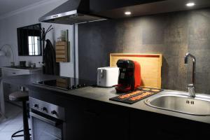 a kitchen with a mixer on a counter next to a sink at Le Duplex appartement proche de la Cathédrale in Bayeux