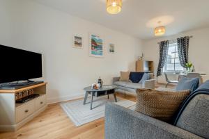 a living room with a couch and a tv at 2 Bed in Bude oc-u31759 in Bude