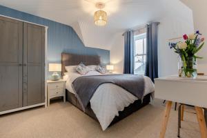 a bedroom with a bed and a vase of flowers at 2 Bed in Bude oc-u31759 in Bude